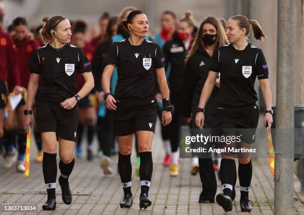 Match Referee Anastasia Pustovoitova makes their way out alongside Assistant Referees Ekaterina Kurochkina and Iuliia Petrova ahead of the UEFA...