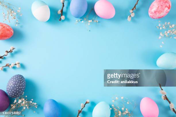 colorful easter eggs on blue background - easter stock pictures, royalty-free photos & images