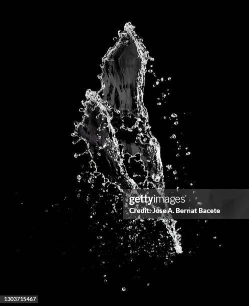 splashes, jet and drops of water in motion suspended in the air on a black background. - air waves stockfoto's en -beelden