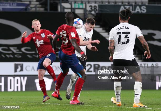 George Edmundson of Derby County scores their sides first goal from a header whilst under pressure from Naby Sarr of Huddersfield Town during the Sky...