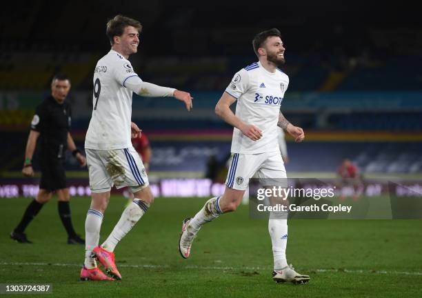 Stuart Dallas of Leeds United celebrates after scoring their sides second goal with team mate Patrick Bamford during the Premier League match between...