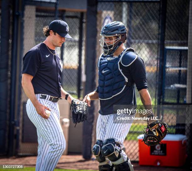 New York Yankees pitcher Gerrit Cole talks with catcher Gary Sanchez after throwing on the mound during a spring training workout at the team's...