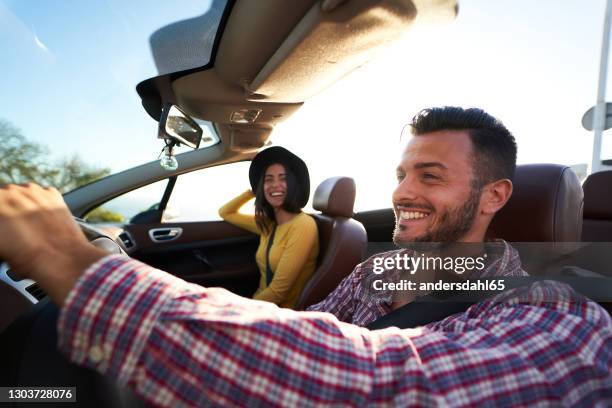 young couple enjoying time in a convertible car - andersdahl65 stock pictures, royalty-free photos & images