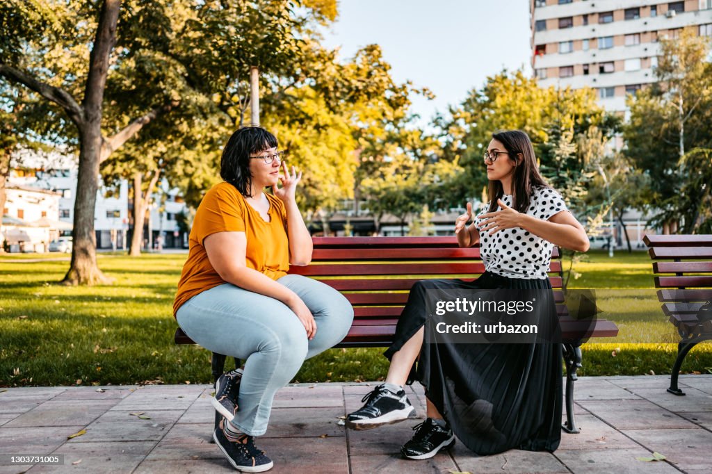 Friends speak in sign language