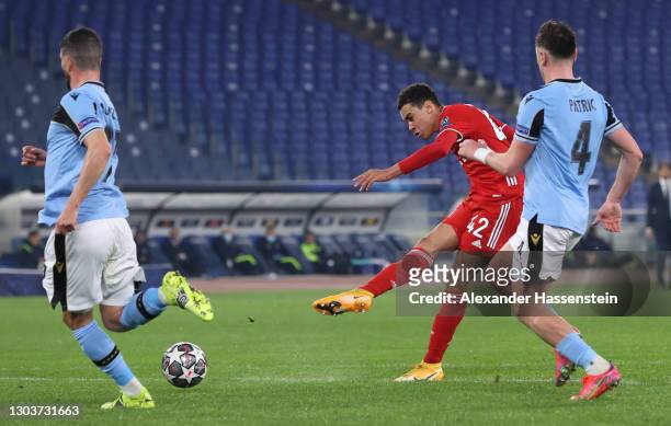 Jamal Musiala of FC Bayern Muenchen scores their sides second goal under pressure from Patric of S.S. Lazio during the UEFA Champions League Round of...