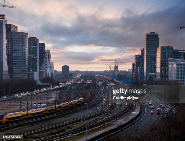 freeway through the zuid-as amsterdam business district - amsterdam zuidas stock pictures, royalty-free photos & images