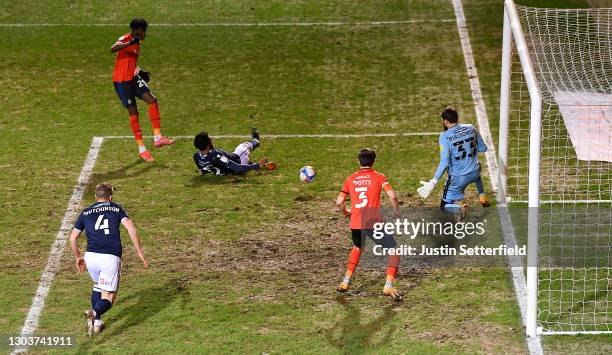 Elijah Adebayo of Luton Town scores their sides first goal past Bartosz Białkowski of Millwall whilst under pressure from Mahlon Romeo of Millwall...