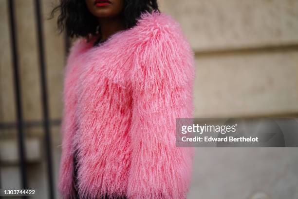 Carrole Sagba aka Linaose wears a pink fluffy winter coat from Anina, on February 20, 2021 in Paris, France.