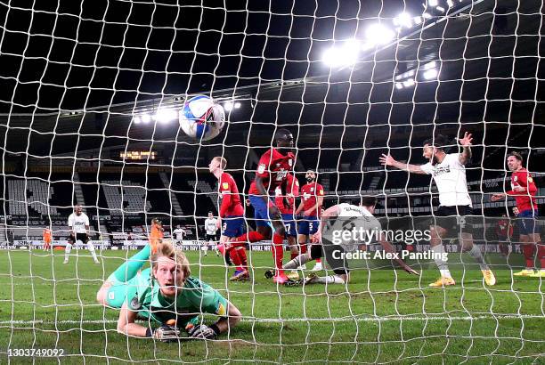 George Edmundson of Derby County scores their sides first goal past Ryan Schofield of Huddersfield Town during the Sky Bet Championship match between...