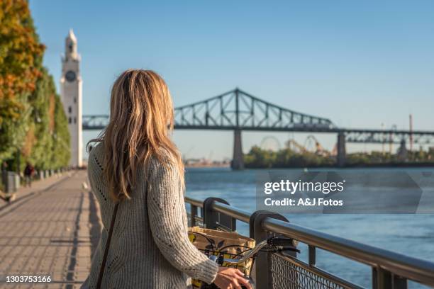 bike ride in montreal. - montreal clock tower stock pictures, royalty-free photos & images