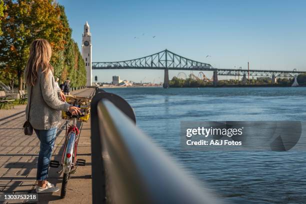 bike ride in montreal. - montreal clock tower stock pictures, royalty-free photos & images