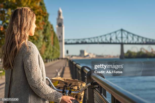 bike ride in montreal. - montreal clock tower stock pictures, royalty-free photos & images