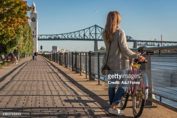bike ride in montreal. - montreal clock tower stock pictures, royalty-free photos & images