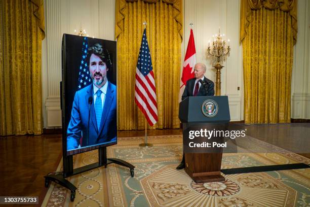 President Joe Biden and Canadian Prime Minister Justin Trudeau deliver opening statements via video link in the East Room of the White House February...