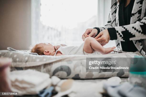 my mother is the best - changing diaper stock pictures, royalty-free photos & images