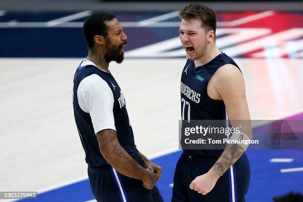 Luka Doncic of the Dallas Mavericks celebrates with James Johnson of the Dallas Mavericks after making the game-winning shot against the Boston...