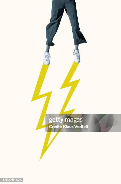 low section of woman with yellow lightning - yellow trousers stock-fotos und bilder