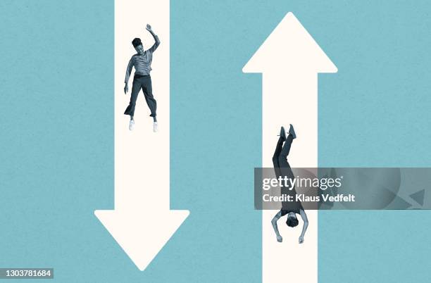 young woman and man falling over white arrows - debilidad fotografías e imágenes de stock