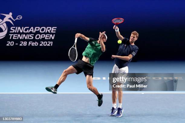 John Millman of Australia and Yannick Hanfmann of Germany return the ball in their Men's Doubles first round match against Luke Bambridge and Dominic...