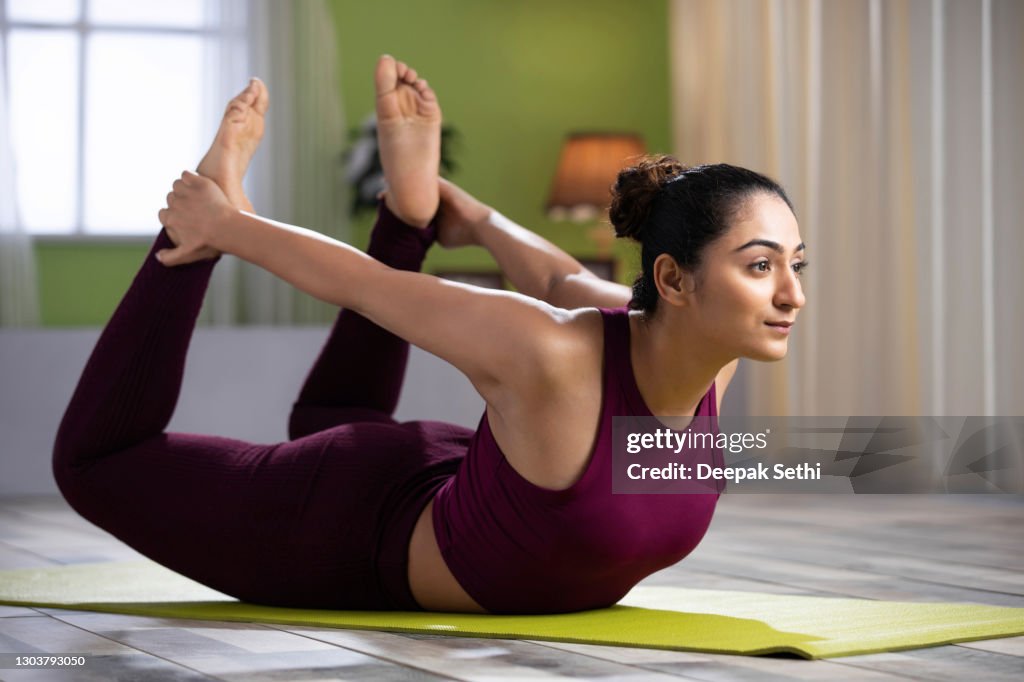 Beautiful Attractive Young Woman Doing Yoga Exercising At Home Health  Concept Fitness Concept Stock Photo High-Res Stock Photo - Getty Images