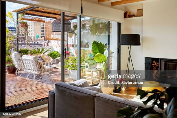sunny living space in barcelona apartment - sliding door stock-fotos und bilder