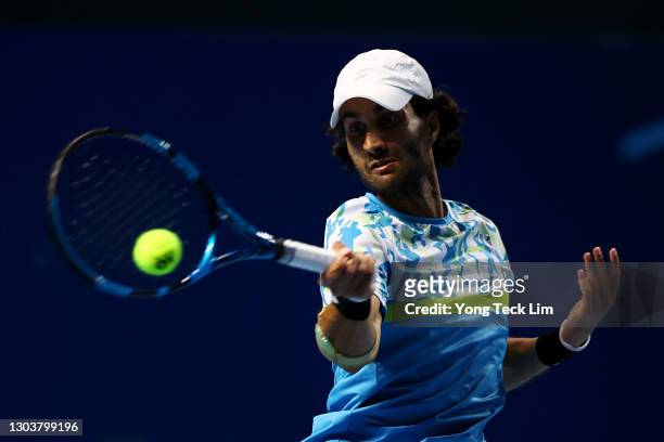 Yuki Bhambri of India plays a forehand in his Men's Singles first round match against Matthew Ebden of Australia on day three of the Singapore Tennis...