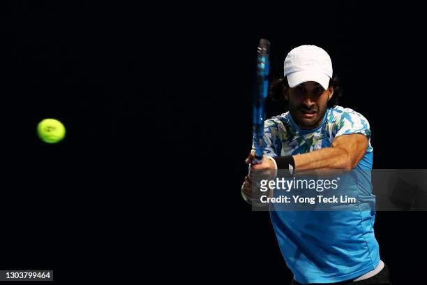 Yuki Bhambri of India plays a backhand in his Men's Singles first round match against Matthew Ebden of Australia on day three of the Singapore Tennis...