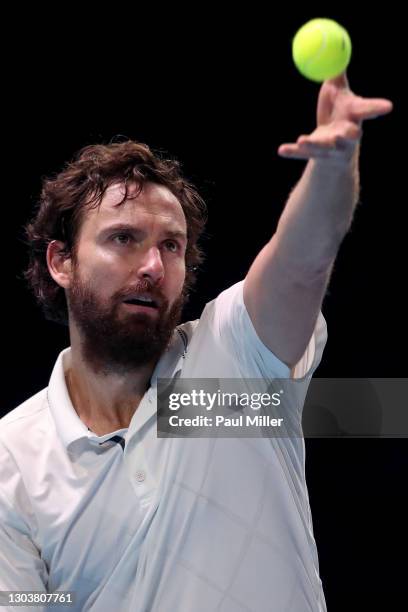 Ernests Gulbis of Latvia serves in his Men's Singles first round match against Roberto Marcora of Italy on day three of the Singapore Tennis Open at...