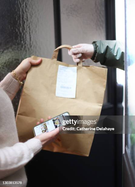 close up of woman receiving take away food delivery - delivery stock pictures, royalty-free photos & images