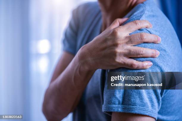 shoulder pain - over shoulder man stockfoto's en -beelden