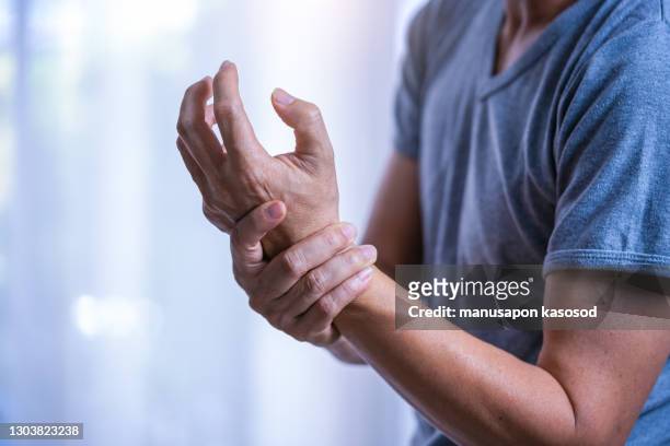 wrist pain - arthritis hands stock-fotos und bilder