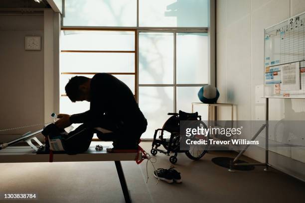 portrait of a paraplegic athlete training in a gym - paralysis stock pictures, royalty-free photos & images