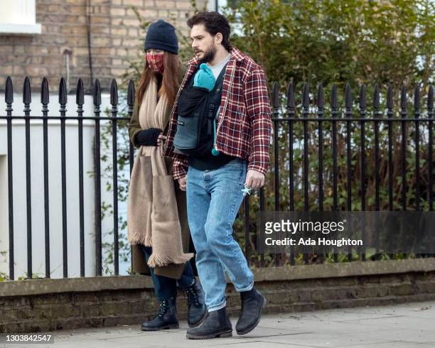 Kit Harington and Rose Leslie seen with their baby boy on a walk in North London on February 24, 2021 in London, England.
