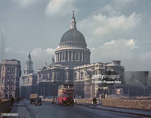 Number 9 bus drives along Cannon Street past St Paul's Cathedral in the City of London in January 1946. Various bomb sites are visible in the...