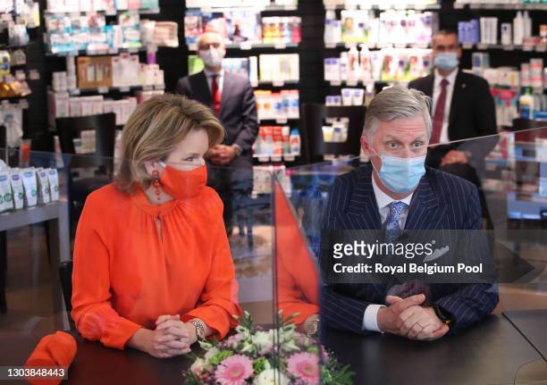 King Philippe and Queen Mathilde of Belgium visit the Pharma Haelvoet pharmacy on February 24, 2021 in Evere, Belgium. The Royal Couple participated...