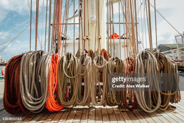 coiled rope at the base of the mast on a large sailing ship. - coiling stock pictures, royalty-free photos & images