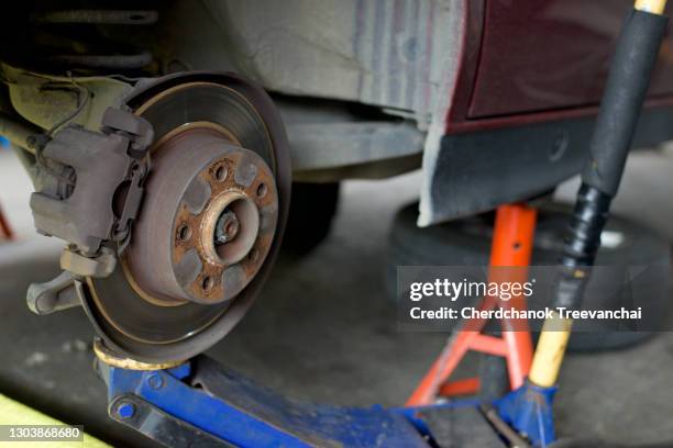 car jack lift up the car for repairing disk brake - tyre bridge stock pictures, royalty-free photos & images