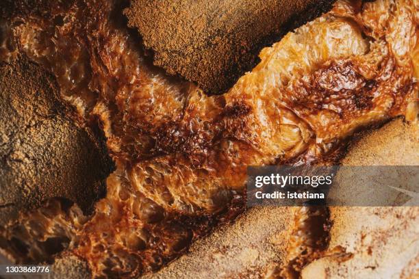 homemade artisan bread on rustic cutting board, texture, close up - bread texture stockfoto's en -beelden