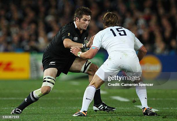 Richie McCaw of the All Blacks takes on Maxime Medard of France during the 2011 IRB Rugby World Cup Final match between France and New Zealand at...