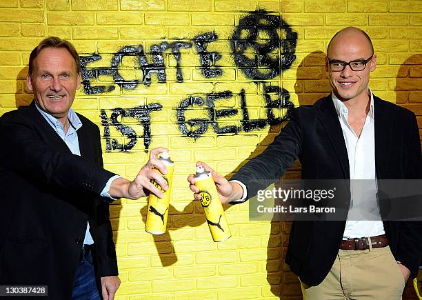 Hans Joachim Watzke, CEO of Borussia Dortmund, and Franz Koch, CEO of Puma, pose during a Borussia Dortmund and Puma press conference at Signal Iduna...