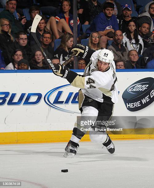 Brooks Orpik of the Pittsburgh Penguins breaks his stick while taking a shot against the New York Islanders at Nassau Veterans Memorial Coliseum on...