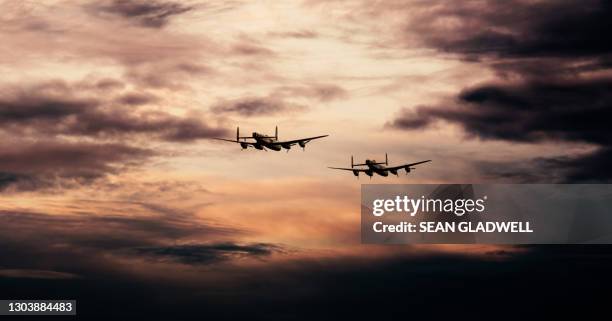 lancaster bombers in flight - bomber stock-fotos und bilder