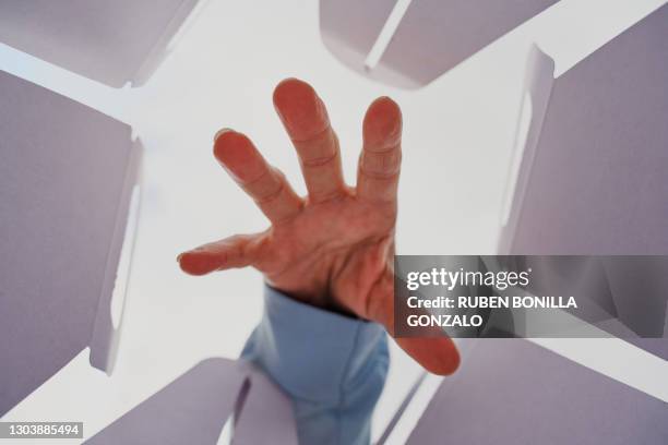 below view of hand in a cardboard box to take someting - catching stock-fotos und bilder