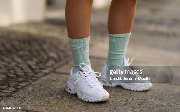 Masha Sedgwick wearing Nike socks and white Skechers sneaker on February 22, 2021 in Berlin, Germany.