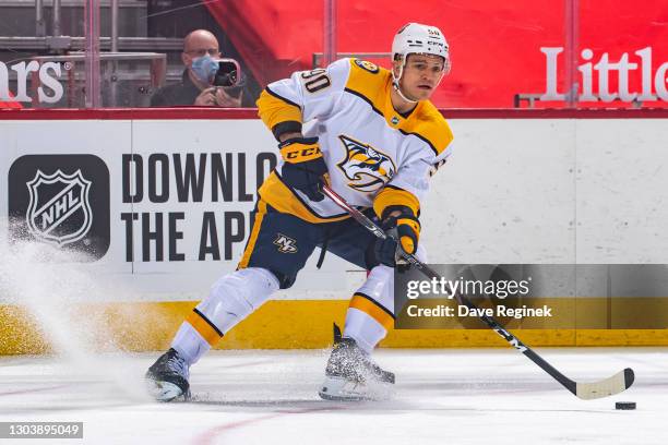 Mark Borowiecki of the Nashville Predators stops with the puck against the Detroit Red Wings during an NHL game at Little Caesars Arena on February...