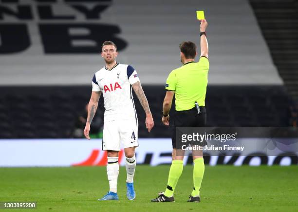 Toby Alderweireld of Tottenham Hotspur is shown a yellow card by Referee Matej Jug during the UEFA Europa League Round of 32 match between Tottenham...