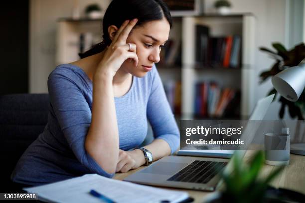 stressed and tired business woman working from home on laptop at home - zoom fatigue stock pictures, royalty-free photos & images