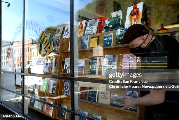 San Francisco, CA - FEB. 23: Employee Don J. Campana adds Lawrence Ferlinghetti books to the window honoring the late Ferlinghetti, a poet,...