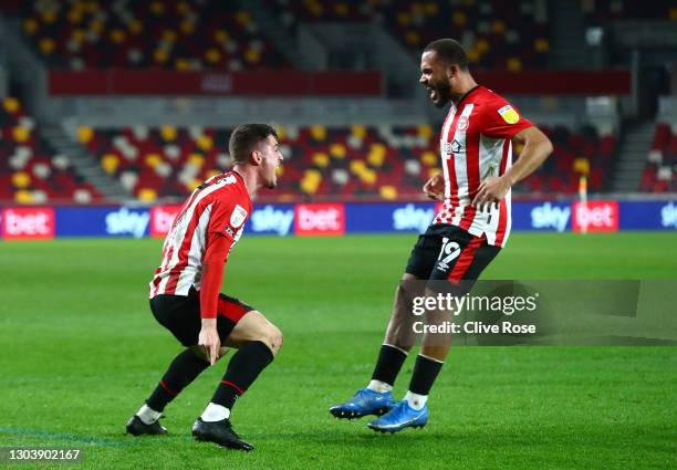 Bryan Mbeumo of Brentford celebrates with Sergi Canos after scoring their team's first goal during the Sky Bet Championship match between Brentford...