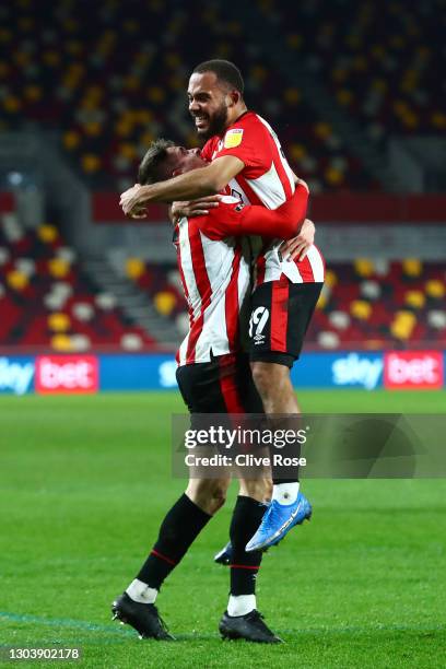 Bryan Mbeumo of Brentford celebrates with Sergi Canos after scoring their team's first goal during the Sky Bet Championship match between Brentford...